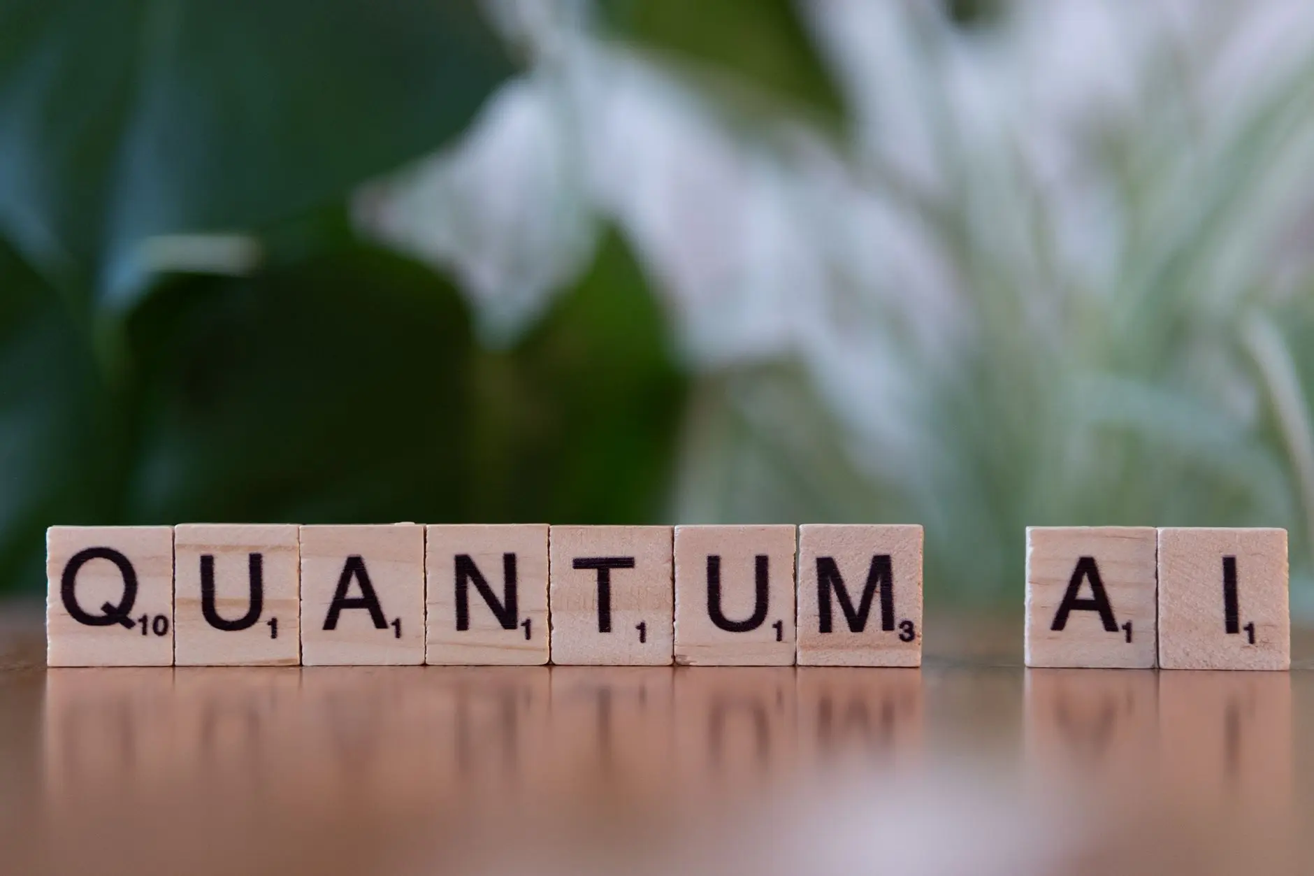 Scrabble tiles spell 'QUANTUM AI' on a wooden surface with a green plant in the background.